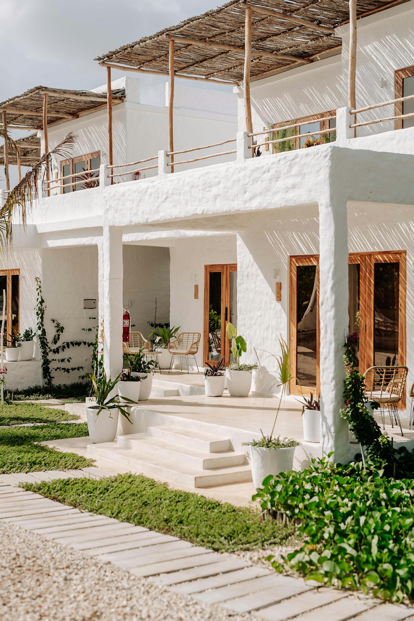 Charming white villa with wooden accents in sunny Jambiani, Tanzania. Ideal for relaxation.
